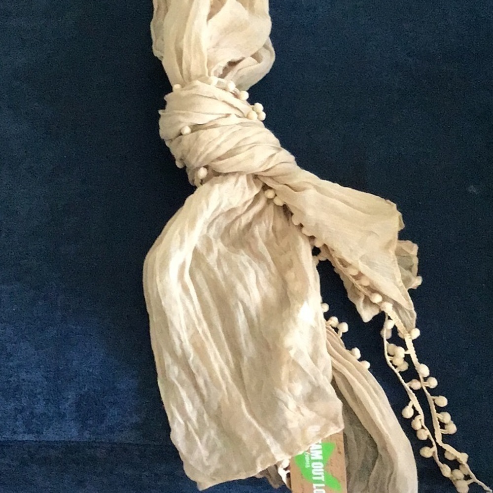 Selena Gomez lightweight tan scarf with Pom Pom detailing